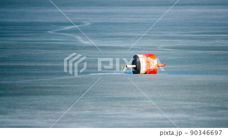 A buoy, is a floating device on the ice of a frozen lake. Emptiness, ice, loneliness, cold, hopelessness 90346697