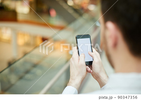 Close-up of unrecognizable businessman texting sms on gadget or searching for information on internet Close-up of unrecognizable businessman texting sms on gadget or searching for information on internet 90347356