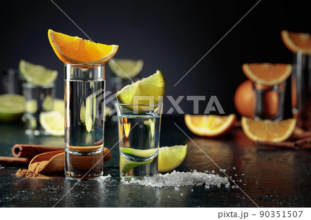 Tequila shots on a black background. Tequila shots on a black background. 90351507