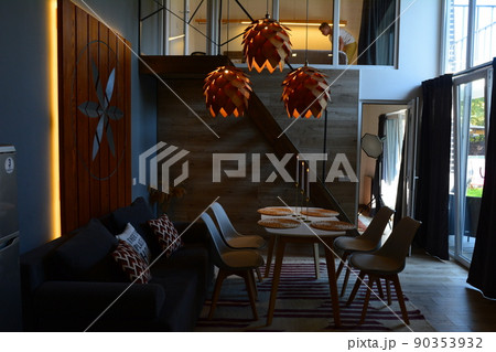 Modern design of rooms in the hotel and at home, hanging chandeliers, sofa and table with chairs, modern Art Nouveau. 90353932