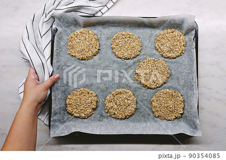 Raw oatmeal cookies on baking sheet ready to bake. Homemade cookies, baking and healthy eating 90354085