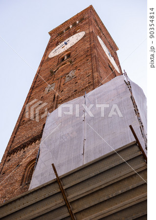 a brick tall old clock tower in italy city 90354814
