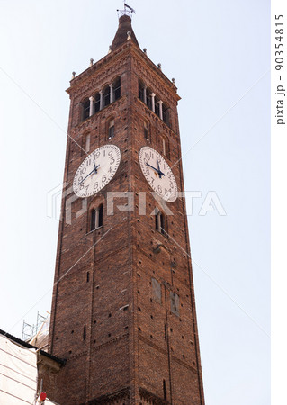 a brick tall old clock tower in italy city 90354815