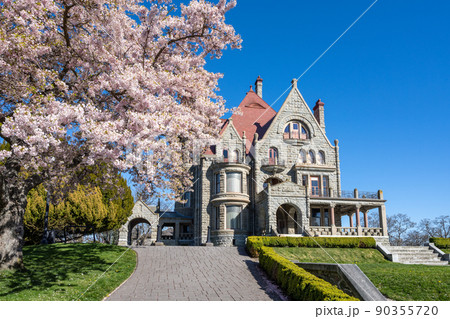 Craigdarroch Castle exterior with full bloom cherry blossom during springtime season. Victoria, BC, Canada. Craigdarroch Castle exterior with full bloom cherry blossom during springtime season. Victoria, BC, Canada. 90355720