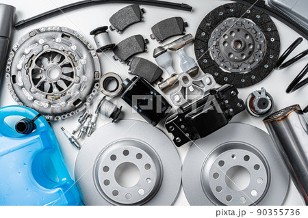 New metal auto parts on grey background 90355736