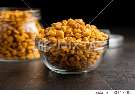 Roasted salted corn snack in bowl on black table. Roasted salted corn snack in bowl on black table. 90357286