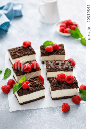Chocolate cube cake, sliced brownie cheesecake with fresh raspberry 90359345