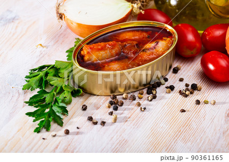 Canned stuffed squid in American sauce in open tin can, nobody 90361165