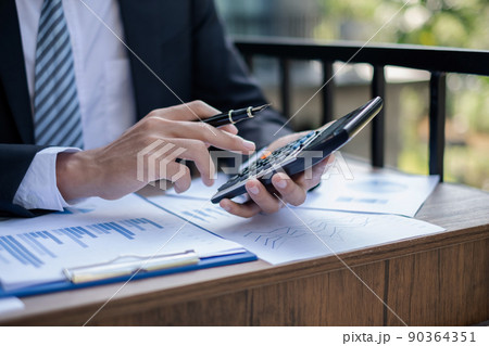Young businessman financial market analyst sits at their desks and calculate financial graphs showing the results of their investments planning the process of successful business growth Young businessman financial market analyst sits at their desks and calculate financial graphs showing the results of their investments planning the process of successful business growth 90364351