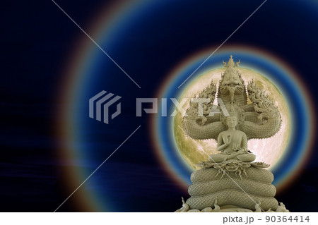 Moon corona light and Buddha protected by the hood of the mythical naga on the night sky Moon corona light and Buddha protected by the hood of the mythical naga on the night sky 90364414