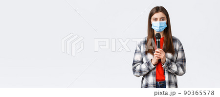 Coronavirus outbreak, leisure on quarantine, social distancing and emotions concept. Girl in medical mask performing song or stand-up, holding microphone want be heard, white background Coronavirus outbreak, leisure on quarantine, social distancing and emotions concept. Girl in medical mask performing song or stand-up, holding microphone want be heard, white background 90365578
