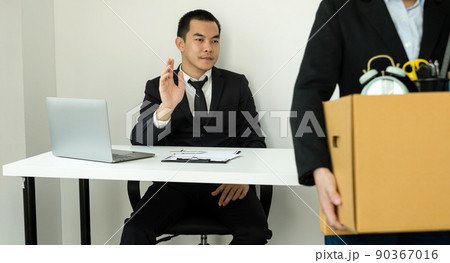 A woman office worker is unhappy with being fired from a company packing things into cardboard boxes. The Young woman was stressed and disappointed by being fired. concept of layoffs and unemployment A woman office worker is unhappy with being fired from a company packing things into cardboard boxes. The Young woman was stressed and disappointed by being fired. concept of layoffs and unemployment 90367016