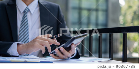 Young businessman financial market analyst sits at their desks and calculate financial graphs showing the results of their investments planning the process of successful business growth 90367738