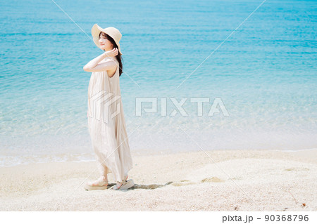 砂浜を歩く女性 90368796