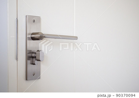 Modern door handle with on white door 90370094