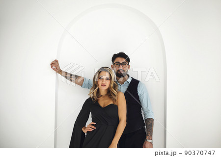 Stylish young ethnic couple embracing against light gray wall 90370747