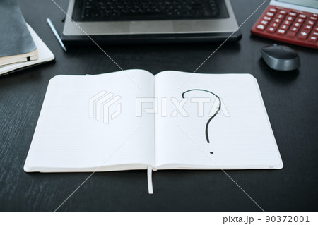 Question mark in a notepad on the background of a laptop and a calculator Question mark in a notepad on the background of a laptop and a calculator 90372001