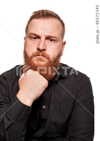 Portrait of a young, chubby, redheaded man in a black shirt making faces at the camera, isolated on a white background Portrait of a young, chubby, redheaded man in a black shirt making faces at the camera, isolated on a white background 90372345