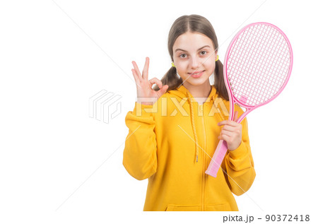 cheerful girl child hold tennis or badminton racket and show ok gesture, healthy childhood. cheerful girl child hold tennis or badminton racket and show ok gesture, healthy childhood. 90372418