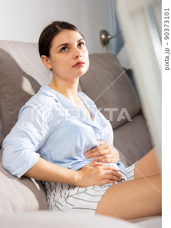 Portrait of a girl suffering from pain in stomach Portrait of a girl suffering from pain in stomach 90373101
