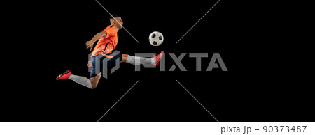 Flyer. Dynamic portrait of professional male football soccer player in motion isolated on dark background. Concept of sport, goals, competition, hobby, achievements Flyer. Dynamic portrait of professional male football soccer player in motion isolated on dark background. Concept of sport, goals, competition, hobby, achievements 90373487
