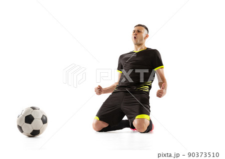 Win, success. Professional male soccer player in black football kit posing with ball isolated on white studio background. Concept of sport, goals, competition, male hobby, occupations 90373510