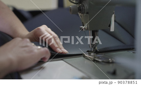 experienced worker works sewing machine. sew leather goods. hands close up. workshop business concept. female hands sew clothes sewing machine. professional seamstress workshop. clothing production. experienced worker works sewing machine. sew leather goods. hands close up. workshop business concept. female hands sew clothes sewing machine. professional seamstress workshop. clothing production. 90378851