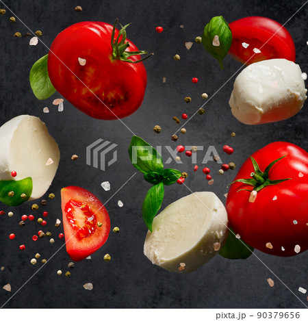 Falling caprese salad ingredients on dark background. Italian appetizer 90379656