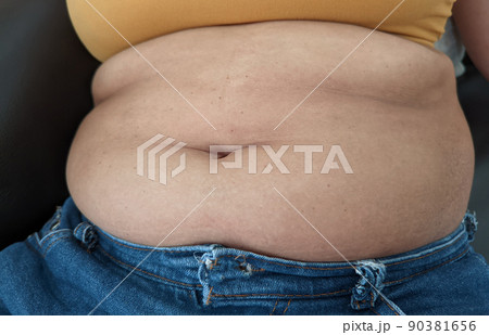 Asian Women sitting on show body fat belly front. 90381656