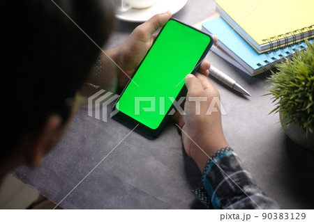 top view of man hand using smart phone on office desk  90383129