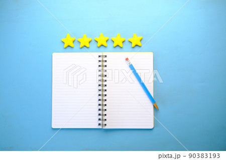 Customer review concept. Rating golden stars and notepad on blue background  90383193