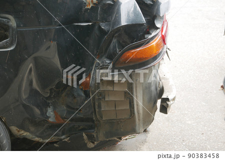 black car damaged by a road accident  90383458