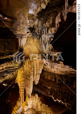 Vertical rock formations in cave large stalactites 90383529