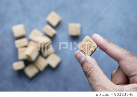 holding a brown sugar cube top view holding a brown sugar cube top view 90383646