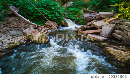 Hidden waterfalls tucked into abandoned area of cement blocks 90383808