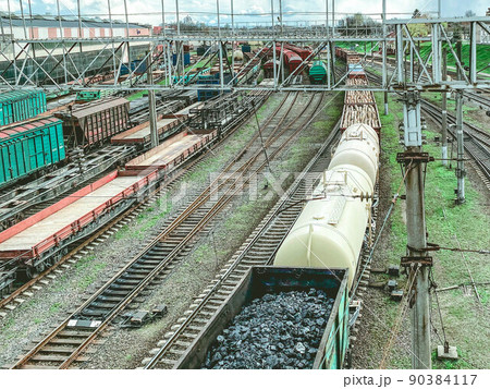 railroad in the city. metal rails. on the road are freight, red freight wagons, large and capacious wagons transport black bulk coal to other countries railroad in the city. metal rails. on the road are freight, red freight wagons, large and capacious wagons transport black bulk coal to other countries 90384117