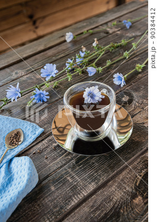 Chicory drink in thermo glass cup with fresh flowers Chicory drink in thermo glass cup with fresh flowers 90384412