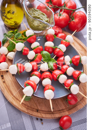 Caprese salad - Mini mozzarella cheese in glass bowl, tomato and basil 90394090