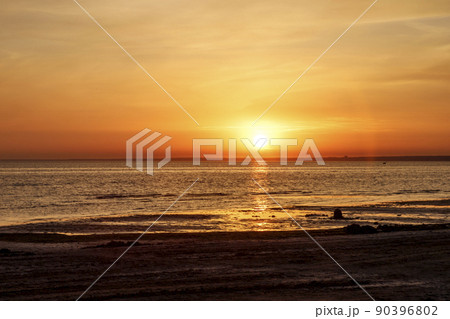 Beautiful sunset over the sea. The sun sets on the water. The sky is painted with golden bright colors. Summer evening. Sunset beach. Beautiful sunset over the sea. The sun sets on the water. The sky is painted with golden bright colors. Summer evening. Sunset beach. 90396802