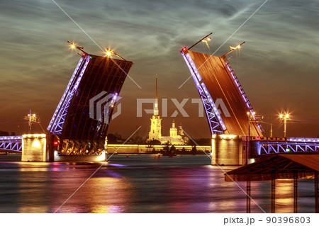 Symbol of Saint-Petersburg, Russia. Summer white night. Raising of Palace bridge over river Neva. The reflection of the illumination in the water. 90396803