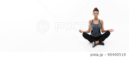 Healthy and Fitness concept - Beautiful American African lady in fitness clothing doing yoga and meditation. Isolated on white background. Healthy and Fitness concept - Beautiful American African lady in fitness clothing doing yoga and meditation. Isolated on white background. 90400519