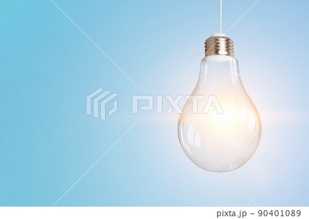Light bulb on light blue background 90401089