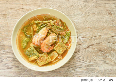 boiled shrimp and fried egg stuffed climbing wattle vegetable in spicy sour soup on plate 90401189