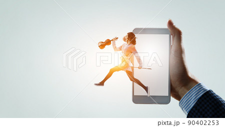 Young pretty businesswoman playing violin Young pretty businesswoman playing violin 90402253