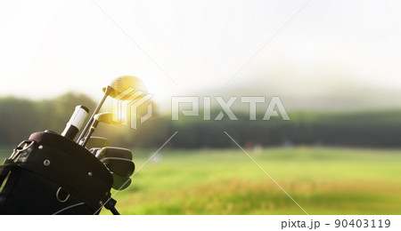 Golf clubs drivers over green field background with copy space 90403119