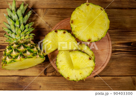 Fresh pineapple on wooden table. Top view Fresh pineapple on wooden table. Top view 90403300