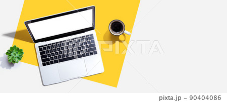 Laptop computer with a coffee cup 90404086