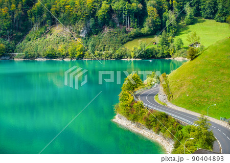 Lungern, canton of Obwalden, Switzerland. The road by the shore of the lake. Lungern, canton of Obwalden, Switzerland. The road by the shore of the lake. 90404893