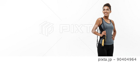 Sport, training, lifestyle and Fitness concept - portrait of beautiful happy African American woman exercising with jumping rope. Isolated on white studio background. Sport, training, lifestyle and Fitness concept - portrait of beautiful happy African American woman exercising with jumping rope. Isolated on white studio background. 90404964