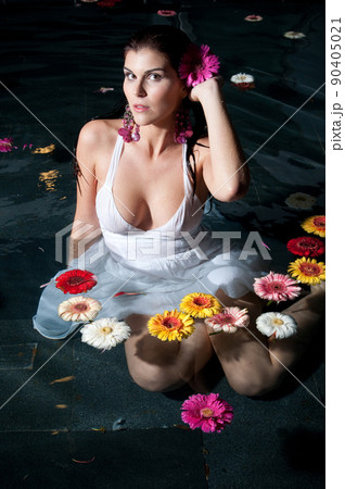 Clothed woman taking a bath at sunset Clothed woman taking a bath at sunset 90405021